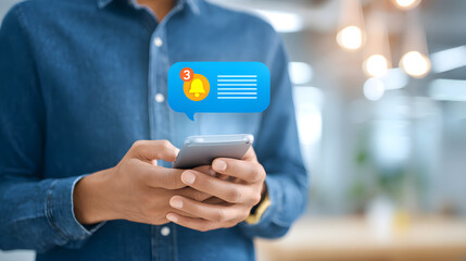 African American man using smartphone with notification bubble in modern office environment