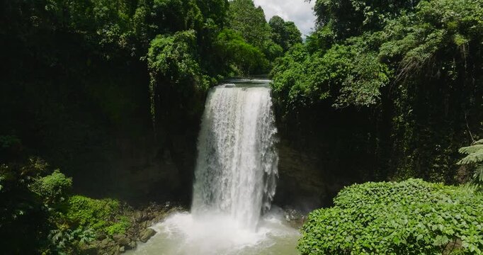 Waterfall in a tropical forest. Aerial survey of Hikong Alo Falls. Lake Sebu. Mindanao, Philippines. Travel concept.