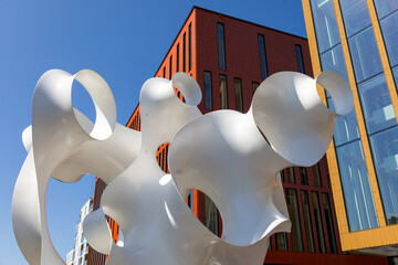 Abstract metal sculpture in Malmö surrounded by urban textures and light