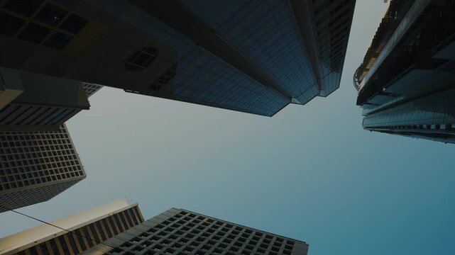 Clear blue sky over skyscrapers in Hong Kong city downtown bottom view. Financial center multistory buildings in Asian megapolis on sunny day. Urban architecture and structure