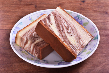 Slices of marble honey spong cake on the plate