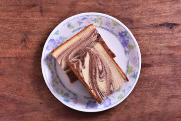 Slices of marble honey spong cake on the plate