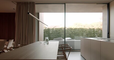 Modern dining room with glass sliding doors opens to patio, wooden table, and minimal interior design. peaceful ambiance. contemporary living and interior design - Powered by Adobe