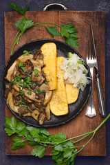Polenta with porcini mushrooms. Traditional Lombardy cuisine, Italian cuisine
