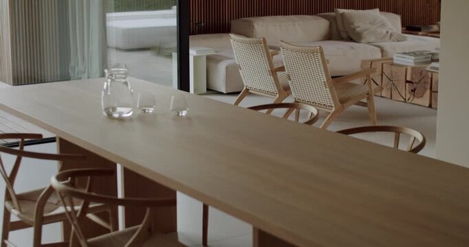 Modern, minimalist dining room interior with natural wood furniture and neutral color palette. dining area with the living room, fostering a sense of togetherness and connection.