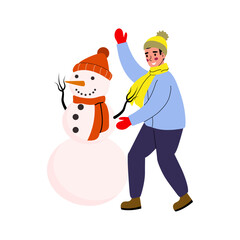 Child builds a cheerful snowman wearing a hat and scarf during winter afternoon in a snowy landscape