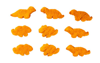 Tasty kids food, dinosaur shaped chicken nuggets. Plate with dino nuggets and sauce and vegetables, healthy and fun air fried dino nuggets