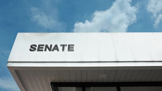 Senate word sign displayed on a monumental governmental building under a clear blue sky, symbolizing legislation, government, politics, democracy, deliberation, lawmaking, and parliamentary authority