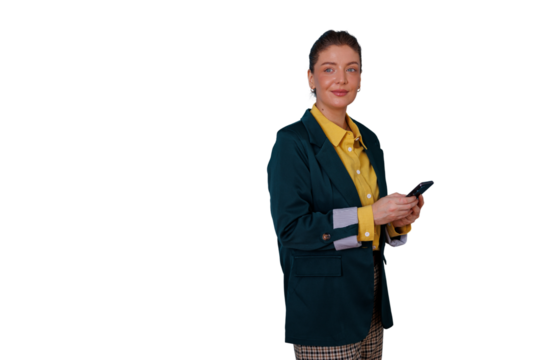Businesswoman smiling, holding mobile phone, standing in corporate attire, communicating using digital device and networking