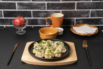 Delicious dumplings served on a black plate in a cozy dining setting