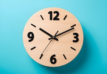 A close up shot of a wooden clock with black numbers and hands on a blue background in studio lighting