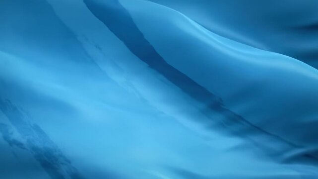 Wide, immersive video of a rich, textured sapphire blue surface with gentle, slow-moving fluid waves and soft folds, soft diffused light creating dynamic highlights, a slow push-in, conveying serene