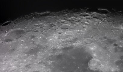 Panoramic view of the Moon surface, showing intricate details of its craters and rugged terrain. The image captures the texture, shadows, and natural formations of the lunar landscape.