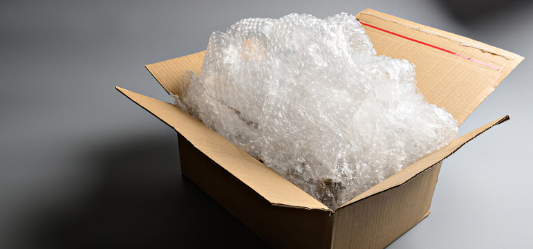 Close-up detail of compressed bubble wrap filler showing texture and protective properties for safe packaging and product protection