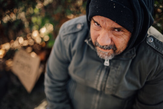 Homeless man looking up asking for help - Powered by Adobe