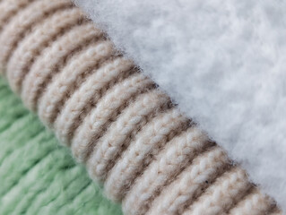 diagonal composition of three rolled cozy fabrics: fleece, ribbed knit and green knit texture