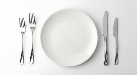 Arrangement of silverware and a clean plate ready for a meal, a dining setting view