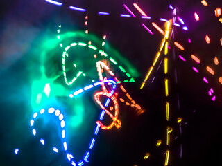 Colorful light particles form digital curves and dots in a light painting effect, creating an energetic and futuristic background.