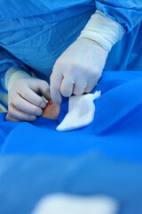 Intravenous injection before surgery. Modern surgery. A real operation. Vertical photo.