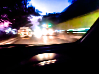 The glossy, reflective surface reflects intense light with a spectrum of bright colors such as purple, orange, and green, creating a dynamic and surreal abstract scene.