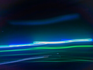 Elegant neon colored lines of light cut through the darkness of the night, giving a futuristic and dynamic impression of speed and movement, like a stunning digital abstract painting