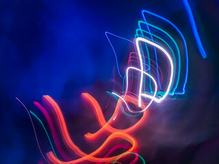 Colorful light particles form digital curves and dots in a light painting effect, creating an energetic and futuristic background.