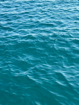 Blue ocean waves vertical background.
