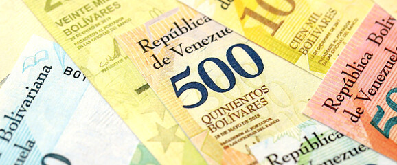 Venezuelan Bolivar currency money bills in bunch. VED currency banknotes with different denomination close up