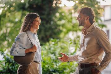 Business partners discussing new project during informal meeting in urban park