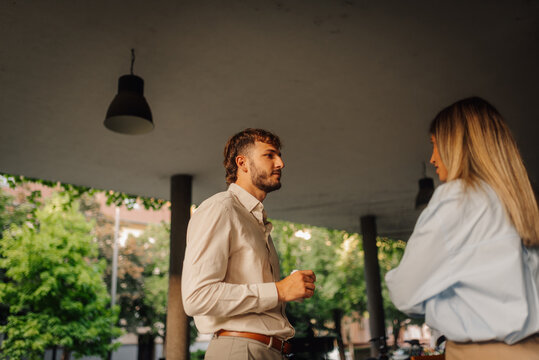 Business partners having informal conversation during coffee break