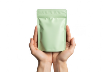 Hands holding a blank green pouch isolated on transparent background, showcasing product packaging design