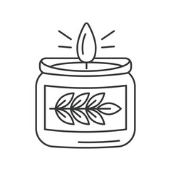 A lit candle in a jar with a leaf design on the label