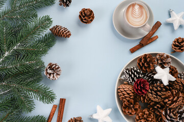 Cup of coffee with pine cones and fir branches