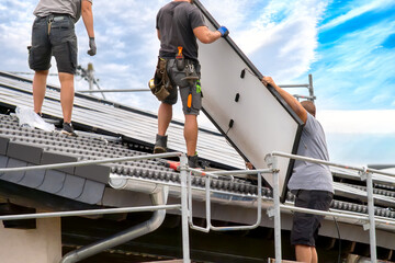 Installation of Solar Panels by Technicians on Rooftop – Sustainable Energy Setup