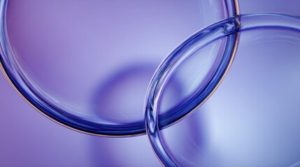 Intertwined, translucent, blueish-purple, three-dimensional rings float against a soft background.
