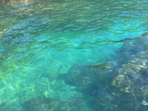 Mediterranean sea clear green water calm surface.