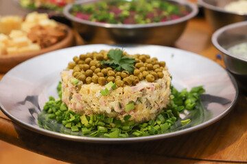 Olivier salad, sandwiches, canapés, bruschetta. A Christmas scene with meat delicacies against a dark wood background. An assortment of cheese and meat appetizers.