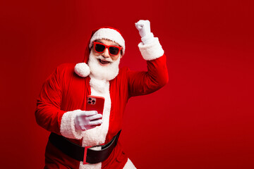 Santa selfie moment in red Christmas costume with sunglass and beard celebrating in festive stock image