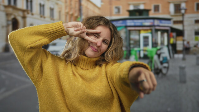 Woman holds hand up while smiling in street scene beside blonde young traveler making peace gesture and pointing toward bicycle in urban setting. - Powered by Adobe