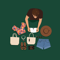 Overhead view Person selecting items. Summer outfit on green background with accessories and clothes
