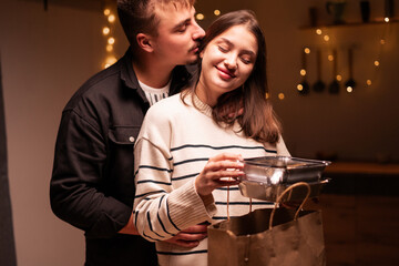 A romantic couple unpacking takeaway food from delivery at home