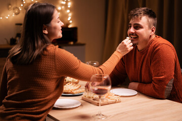 Celebrating Valentines day or anniversary. couple in love having romantic dinner date sitting at table woman feeding her man.