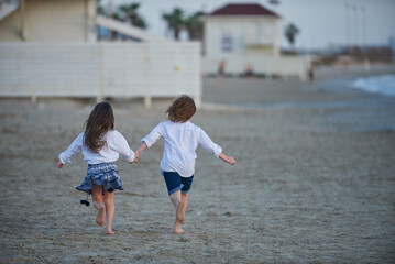 Boy and girl on the beach one summer evening