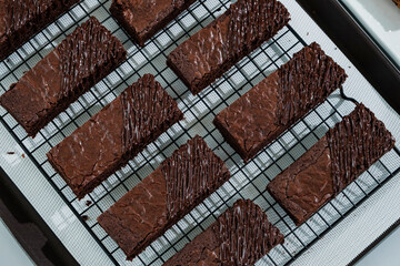 many chocolate brownies in baking tray on white table