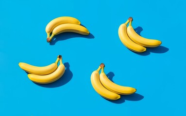 Ripe Yellow Bananas on Bright Blue Background Pattern Flat Lay