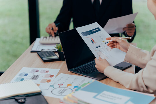 Financial Discussions and Analysis: Business professionals delve into financial reports, analyzing data, and strategizing in a collaborative work environment.