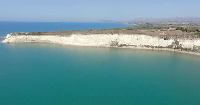 Panoramic aerial view of Eraclea Minoa beach, located in province of Agrigento, Sicily, Italy. It's characterized by a high white cliff. It's a beautiful sunny day. The Mediterranean sea in foreground