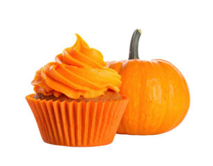 A vibrant cupcake with swirled orange frosting next to a small pumpkin, isolated on black