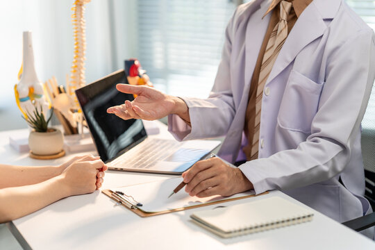 Consultation and Compassion: A doctor in a pristine examination room engages in a thoughtful conversation with a patient, demonstrating care and offering reassurance.