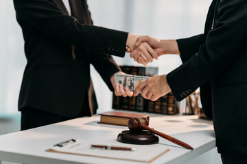 Deal and legal deal handshake: A compelling image portrays a handshake sealing a deal, money...